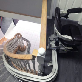 Curved stairlift ends elegantly on top of the stairs